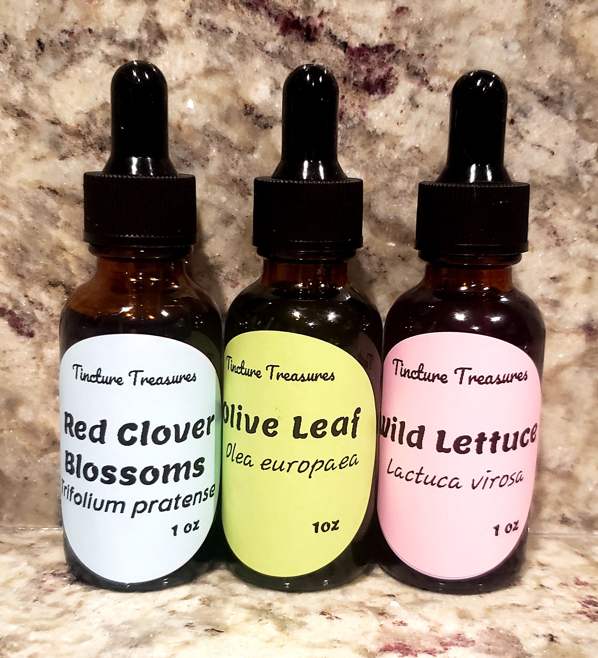 Assorted Tincture Sample Pack #3 with three 1 oz bottles from Tincture Treasures, displayed on a wooden surface.