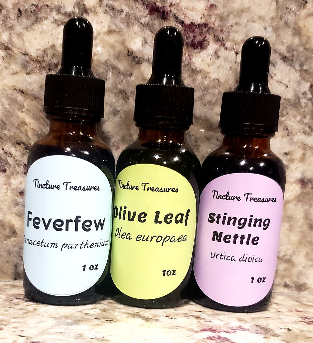 Assorted Tincture Treasures sample pack with four 1 oz tincture bottles arranged on a wooden surface.