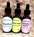 Assorted Tincture Treasures sample pack with four 1 oz tincture bottles arranged on a wooden surface.