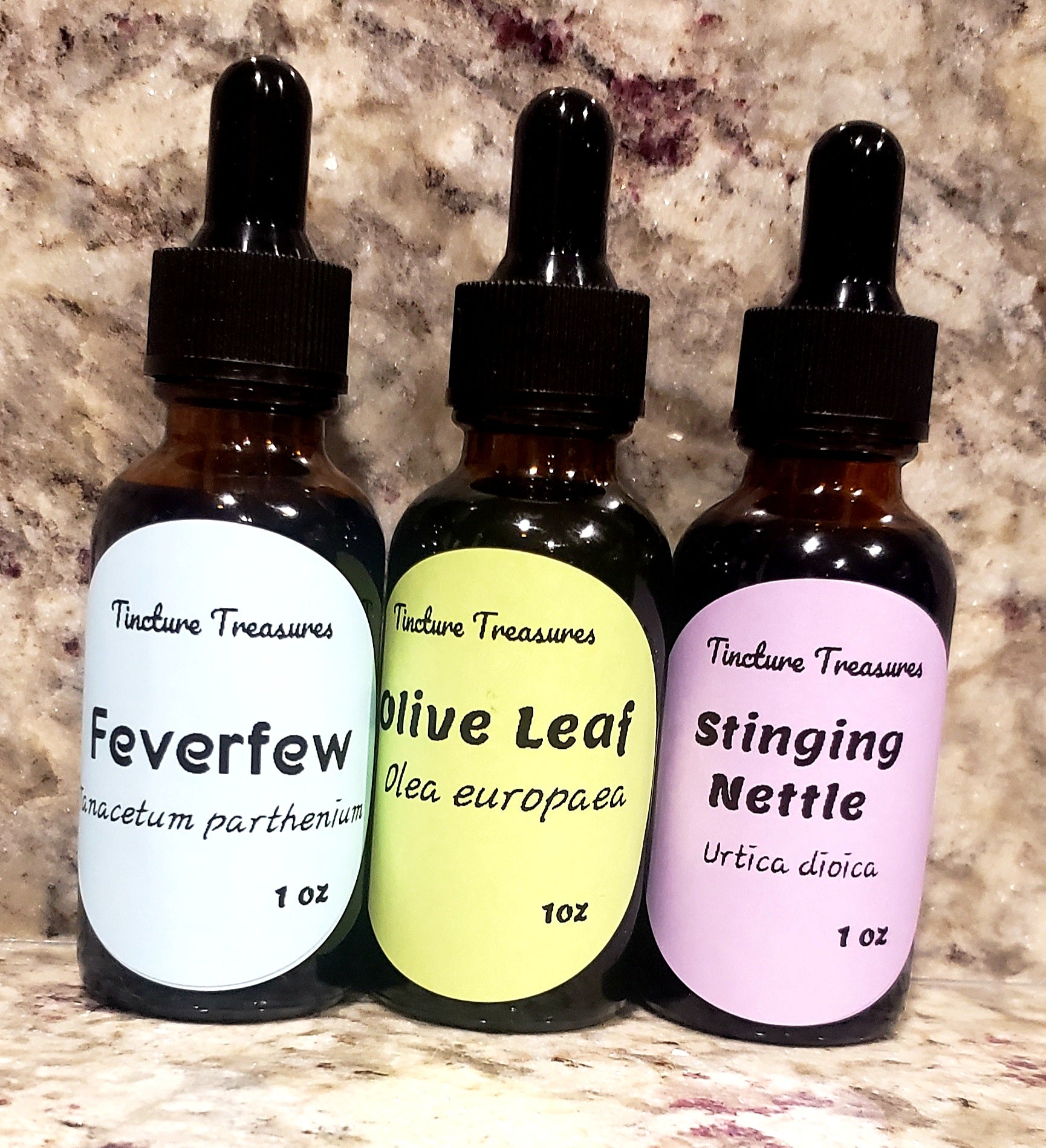 Assorted Tincture Treasures sample pack with four 1 oz tincture bottles arranged on a wooden surface.