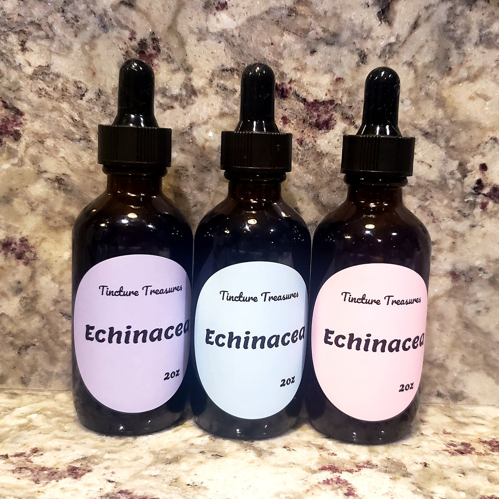 Three amber glass dropper bottles labeled 'Tincture Treasures Echinacea' with lavender, light blue, and pale pink labels, set against a mottled stone countertop.
